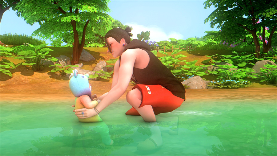 浅瀬で息子をそっと水につける傑